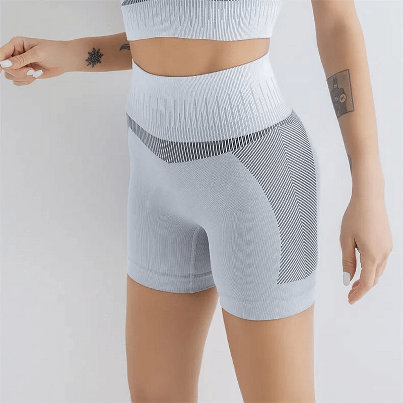 Elastic breathable women's high-waisted shorts in light grey, ideal for yoga and running, featuring soft nylon-spandex blend.