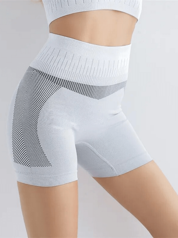 Woman wearing elastic breathable high-waisted shorts for yoga or running in a nylon spandex blend, SF1614.