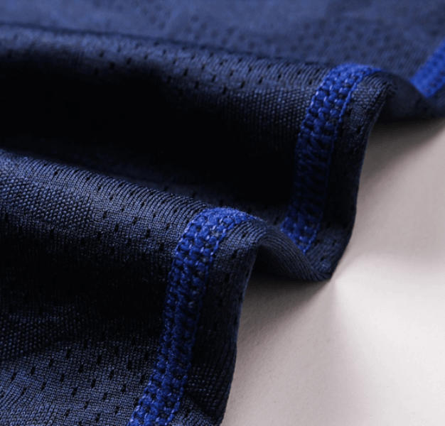 Close-up of blue elastic compression quick-drying men's leggings fabric showing stitching details and texture.