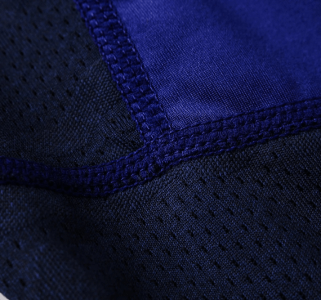 Close-up of elastic compression quick-drying men's leggings fabric and stitching, showcasing durable polyester-spandex blend material.