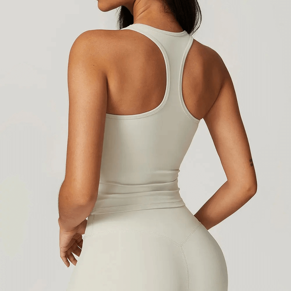 Woman wearing a sleek, quick-dry fitness tank top designed for high-intensity workouts, showcasing the breathable and flexible fabric.