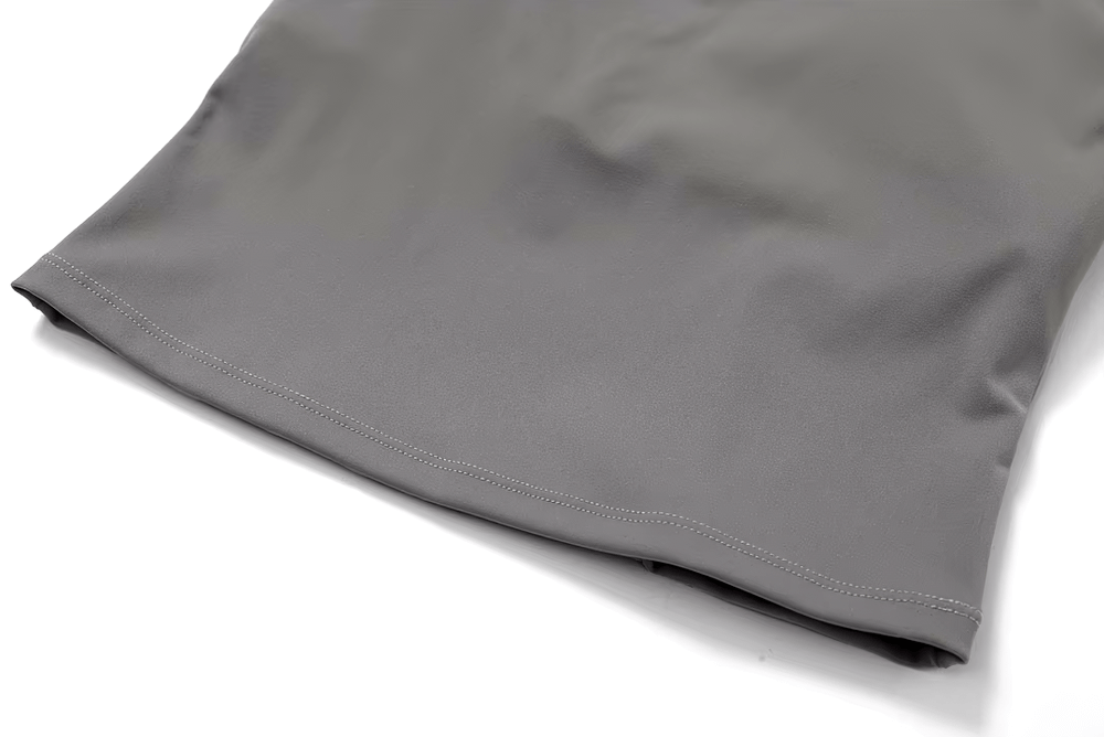 Close-up of gray quick-dry fitness tank top hem, highlighting breathable nylon-spandex fabric for women's workouts.