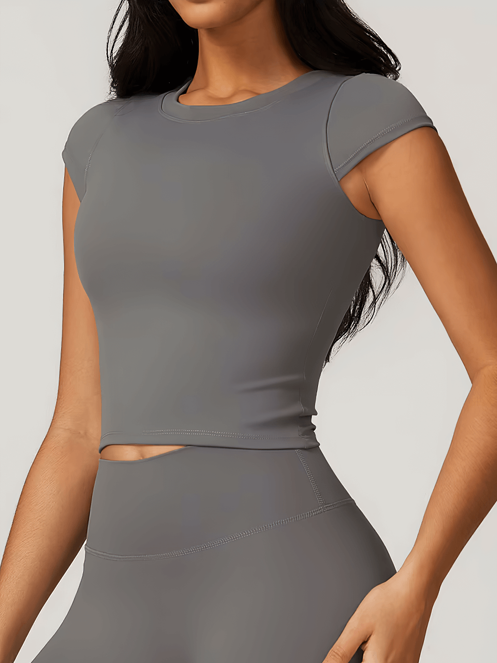 Women’s elastic short sleeve sport T-shirt in gray, ideal for yoga, running, and activewear. Nylon spandex, breathable, quick-dry.