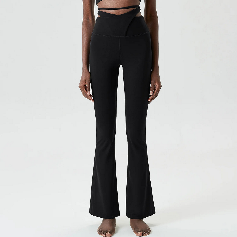Woman wearing black elastic flare yoga pants with tie-up detail, perfect for stylish fitness fashion.