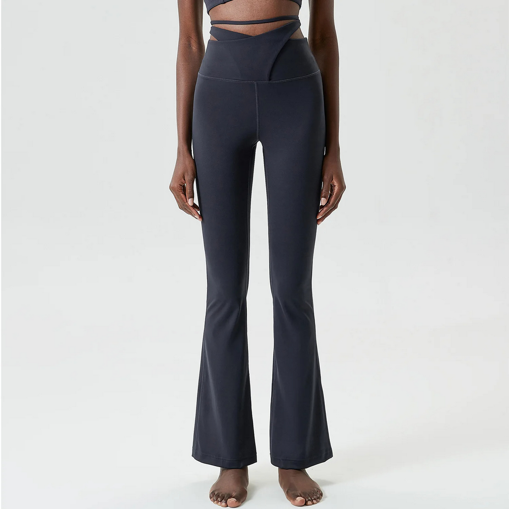 Emerald green elastic flare yoga pants with tie-up waist detail and bell bottom design, perfect for stylish fitness and casual wear.