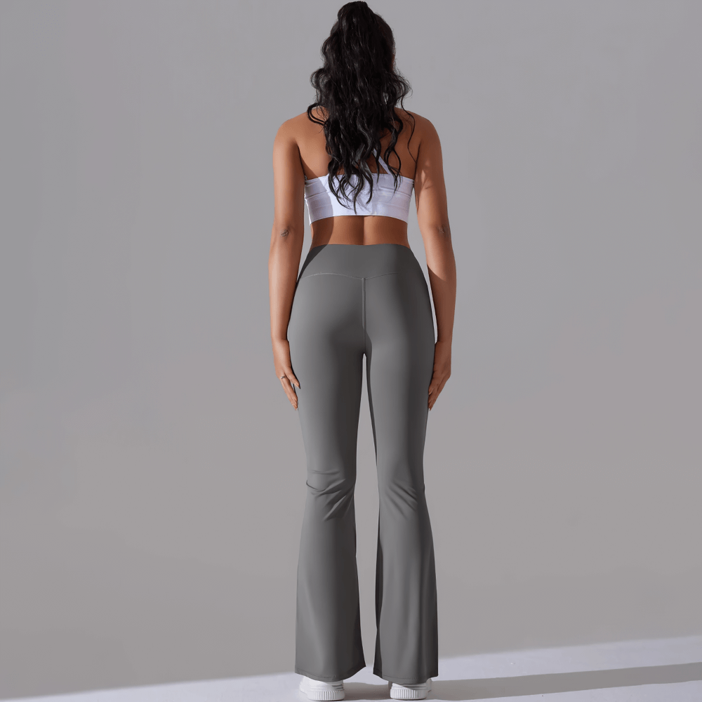 Back view of woman wearing grey high-waist flare leggings perfect for yoga or casual outings, showcasing a stylish and body-lifting fit.