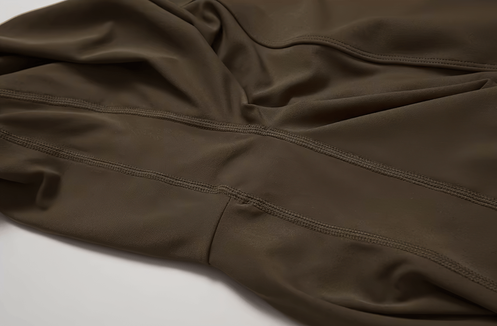 Close-up of brown elastic high-waist flared yoga pants fabric, showcasing detail of the nylon and spandex blend.