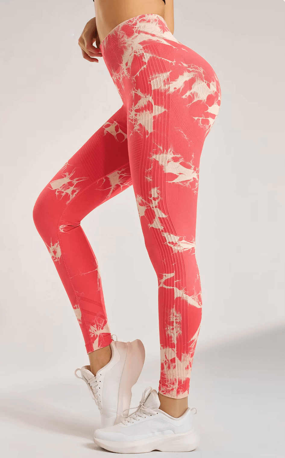 Model wearing seamless high-waisted tie-dye yoga leggings in pink, showing tummy tuck design and ankle-length fit for women, SF2413.