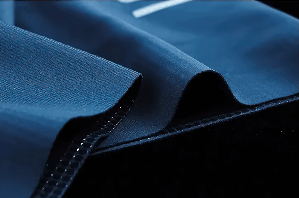 Close-up of blue breathable cycling bib shorts fabric showing anti-slip grip technology, ideal for high-performance road cycling.