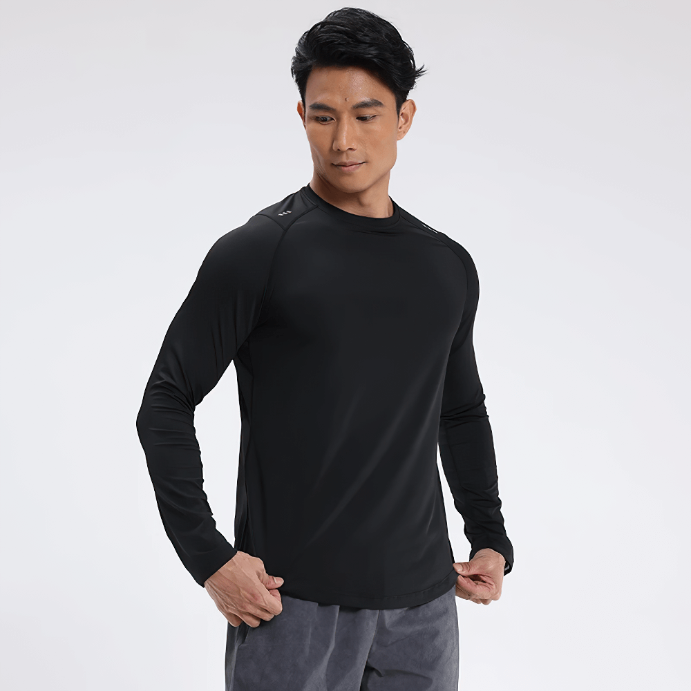 Man wearing black long sleeve sports top for running and fitness, designed with quick-dry and sun protection features.