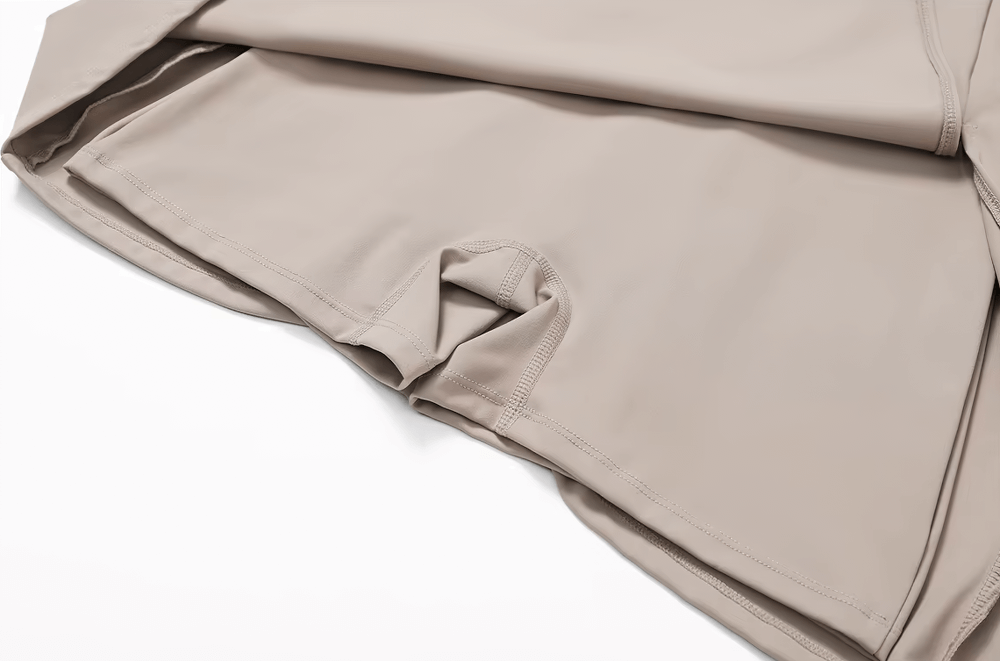 Close-up of a sleeveless, beige one-piece sports yoga dress for women, featuring breathable fabric and stylish design, perfect for active wear.