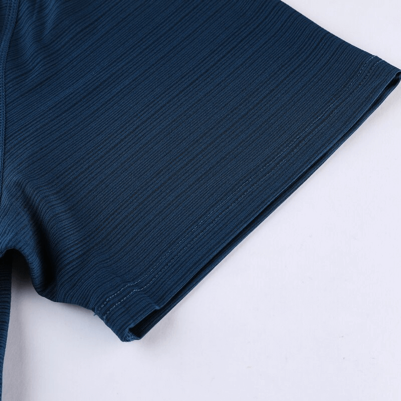 Close-up of a navy blue quick-dry men's t-shirt sleeve, showcasing breathable fabric for sports and fitness activities.