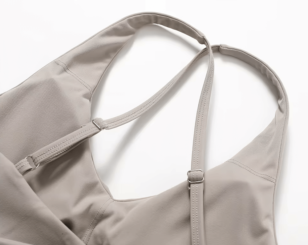 Close-up of a beige racerback sports bra highlighting adjustable straps and breathable fabric, designed for yoga and active workouts.