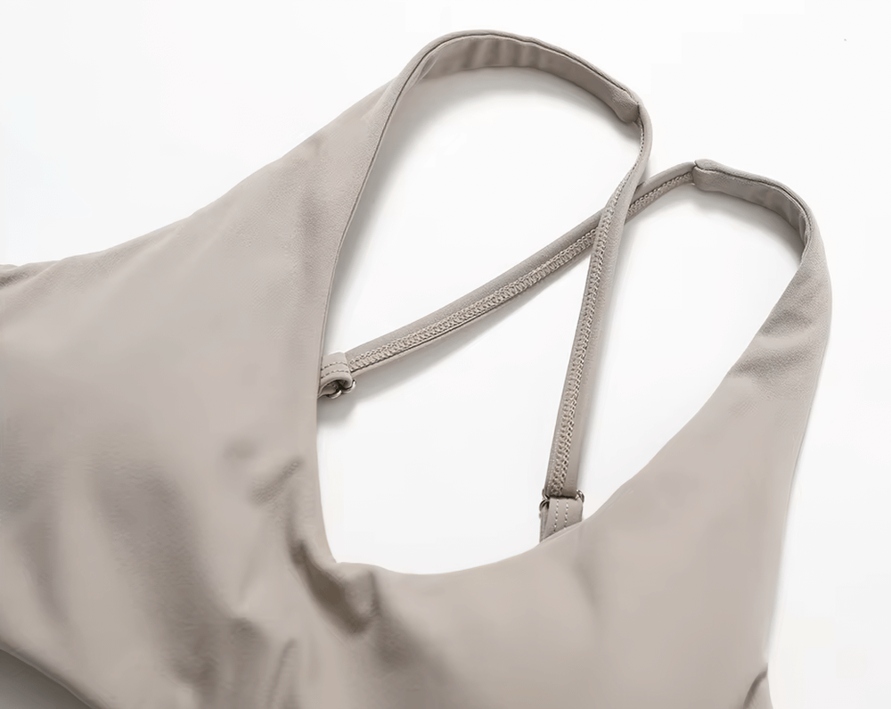 Close-up of a neutral tone racerback sports bra, perfect for yoga and fitness, featuring breathable fabric and sleek design.