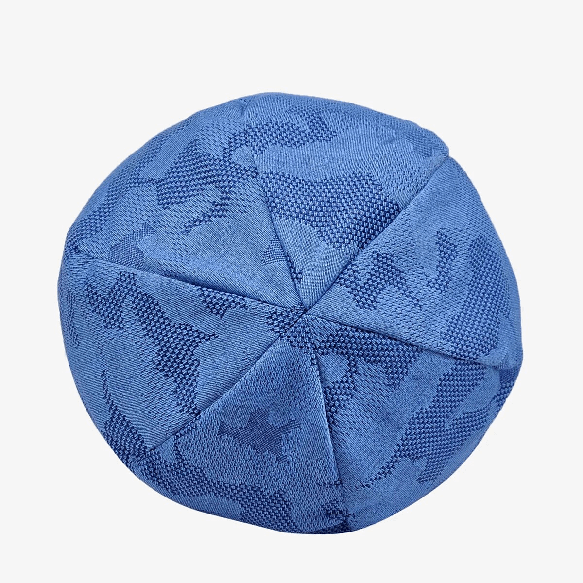 Top view of elastic soft baggy blue beanie with geometric pattern for men and women, made of cotton and polyester.