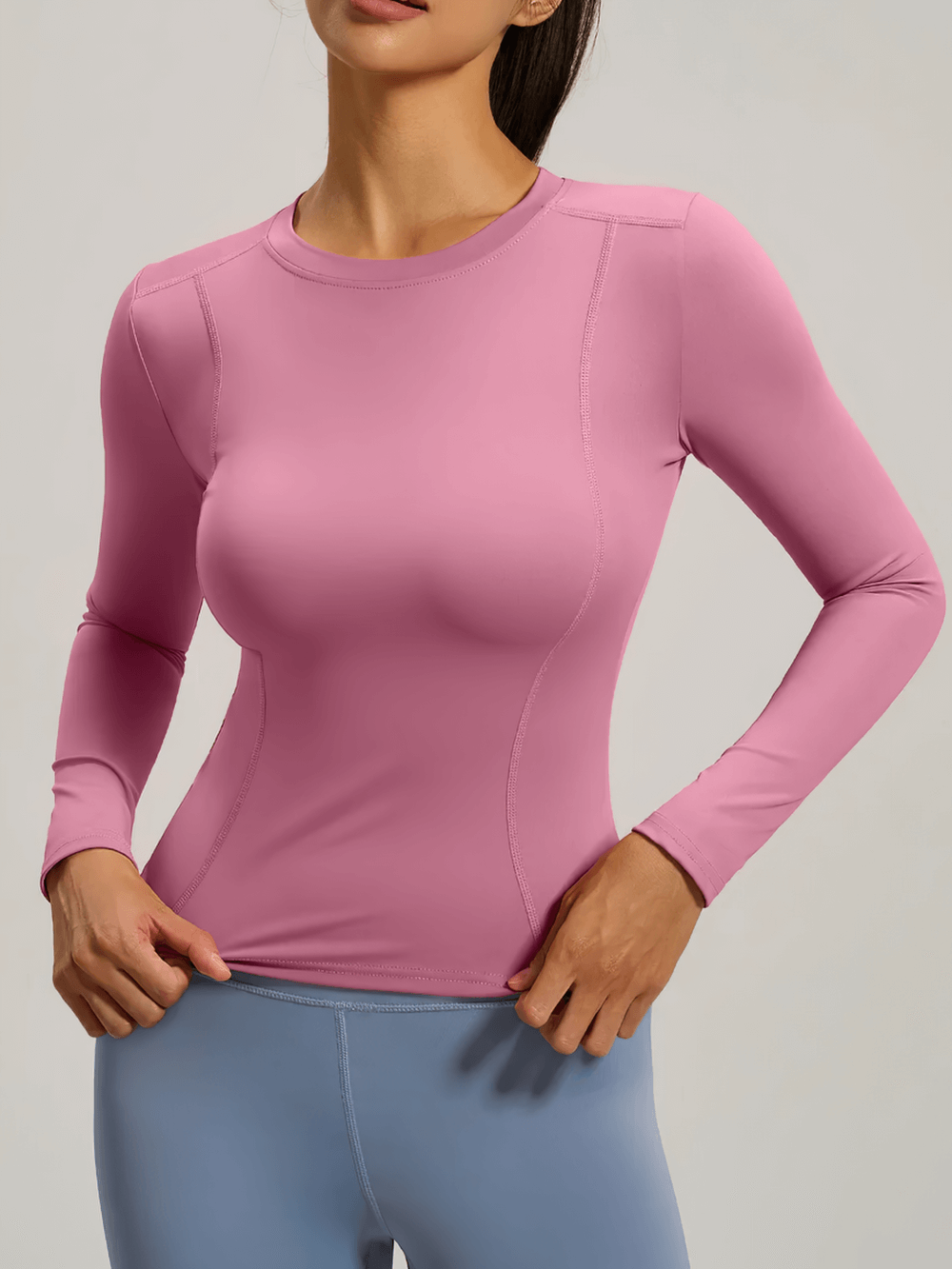 Woman wearing a pink Elastic Sport Long Sleeve Top for Women - SF4131, ideal for yoga and fitness, showcasing breathable and quick-dry fabric.