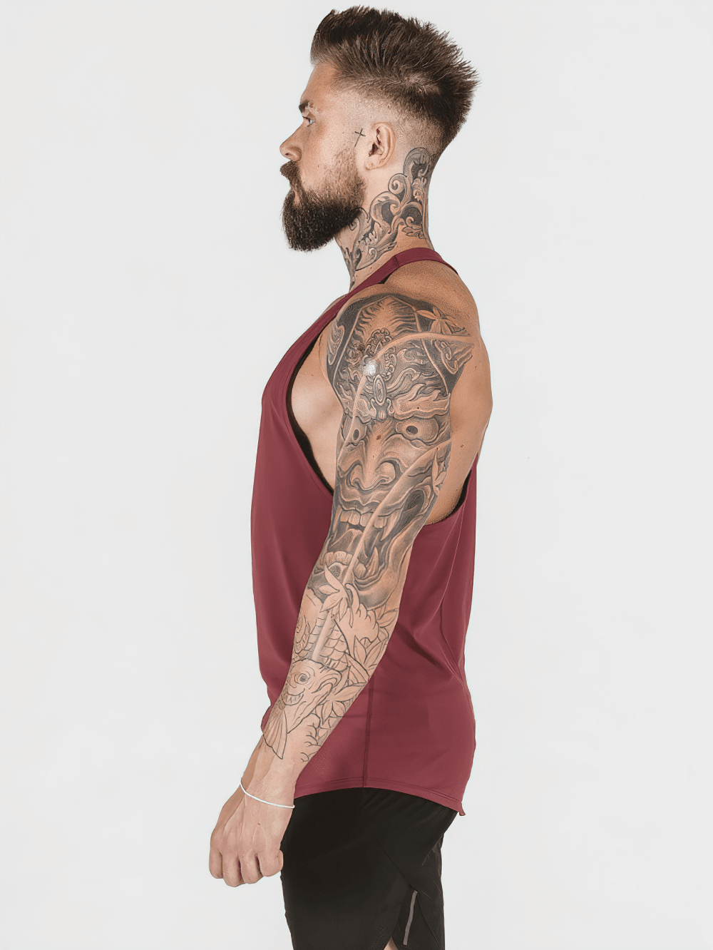 Side view of a man wearing an Elastic Stringer Tank Top for Bodybuilding Training - SF4167, showcasing back design and fit.