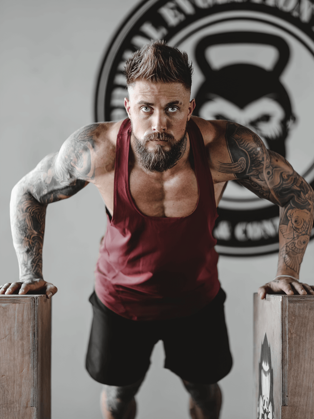 Man in Elastic Stringer Tank Top for Bodybuilding Training - SF4167 doing push-ups in gym.