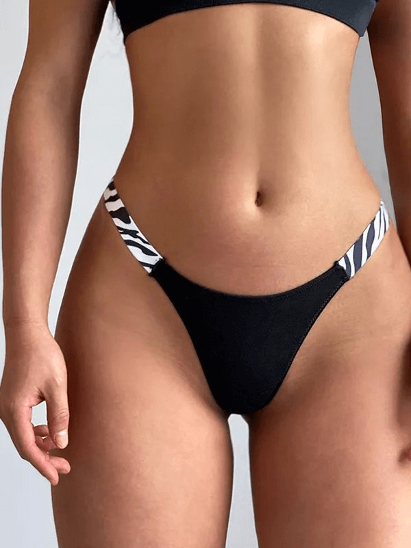 Elastic stylish women's thongs with zebra side print, low-rise G-string fit, cotton-polyester blend, designed for comfort and flair.