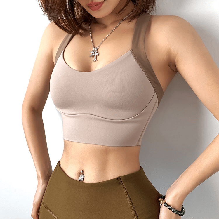 Woman wearing Elastic Support Women's Sports Bra, ideal for training, featuring elastic closure and quick dry nylon for comfort.