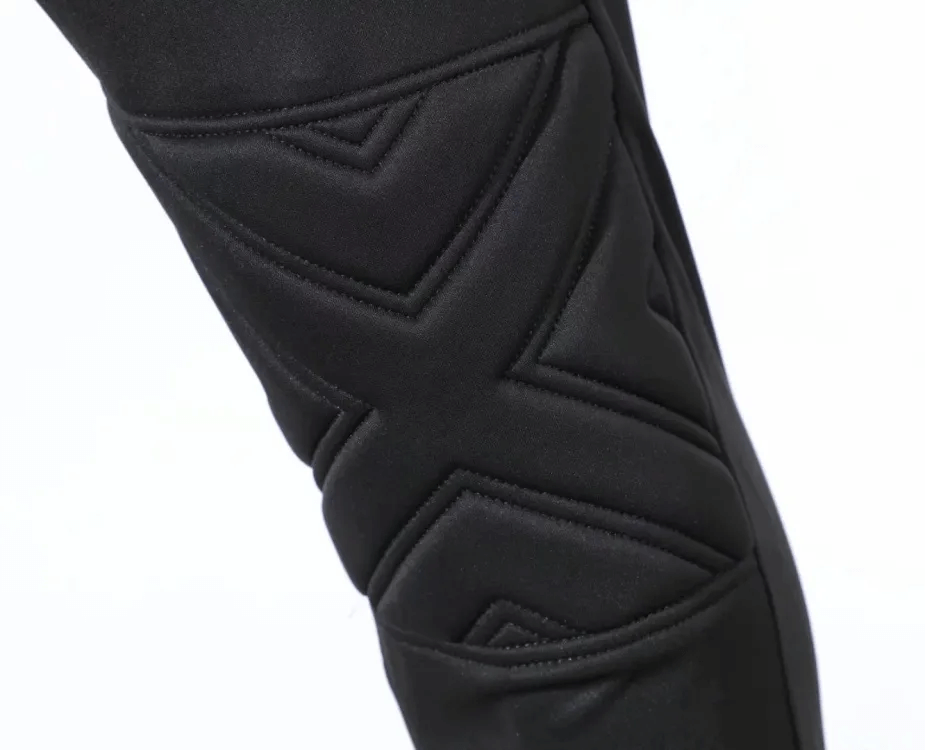 Close-up view of padded protective detailing on black men's training pants, showcasing elastic waist design.