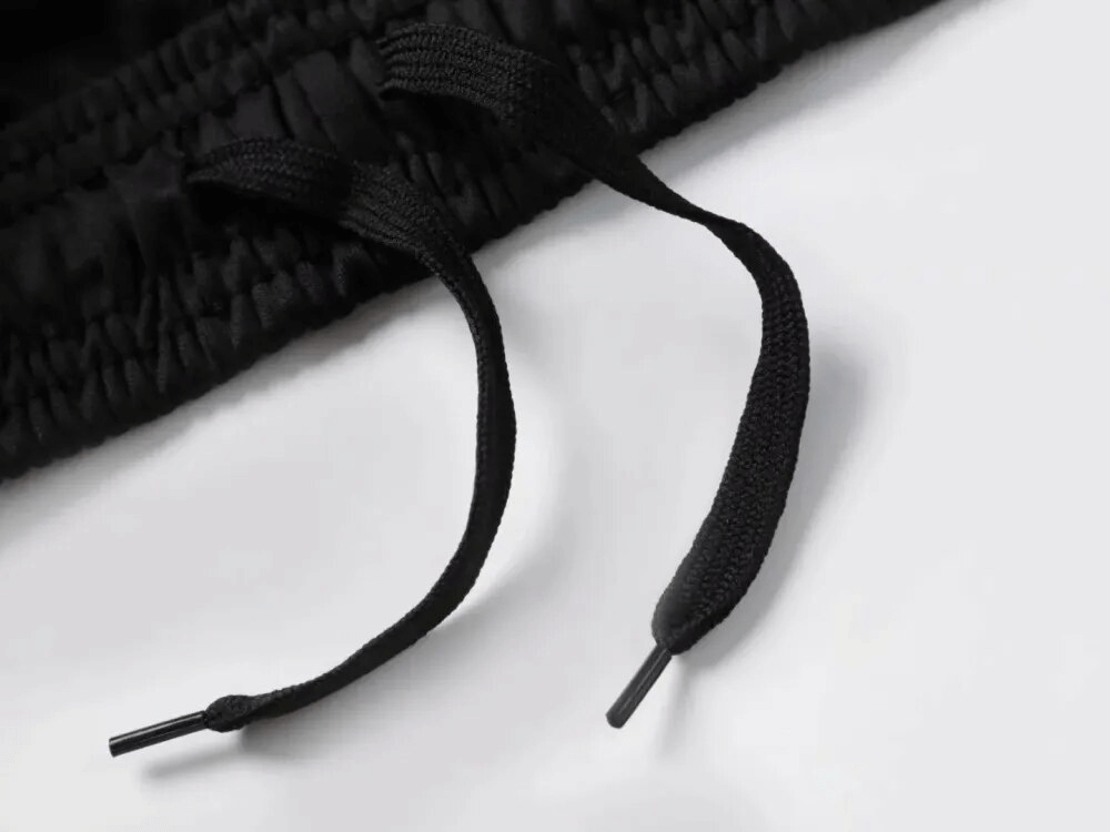 Close-up of elastic waist and drawstring on men's protective training pants, showcasing quality craftsmanship and durability.