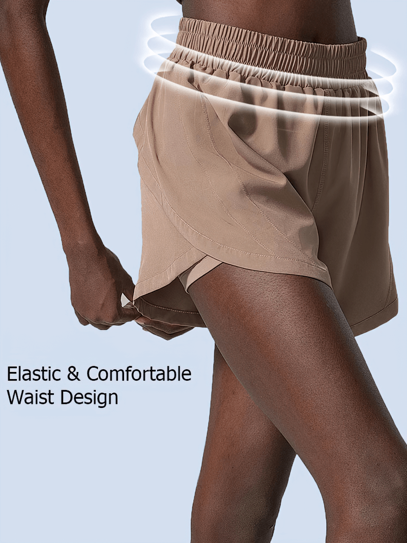 Elastic waist beige shorts with flexible waistband, ideal for active wear. Features breathable fabric and secure fit for comfort.
