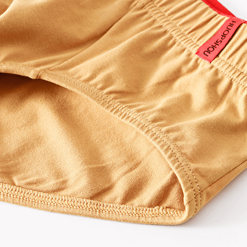 Elastic waist solid color cotton men's briefs in tan with red label, breathable and comfortable casual underwear, ideal for everyday wear.