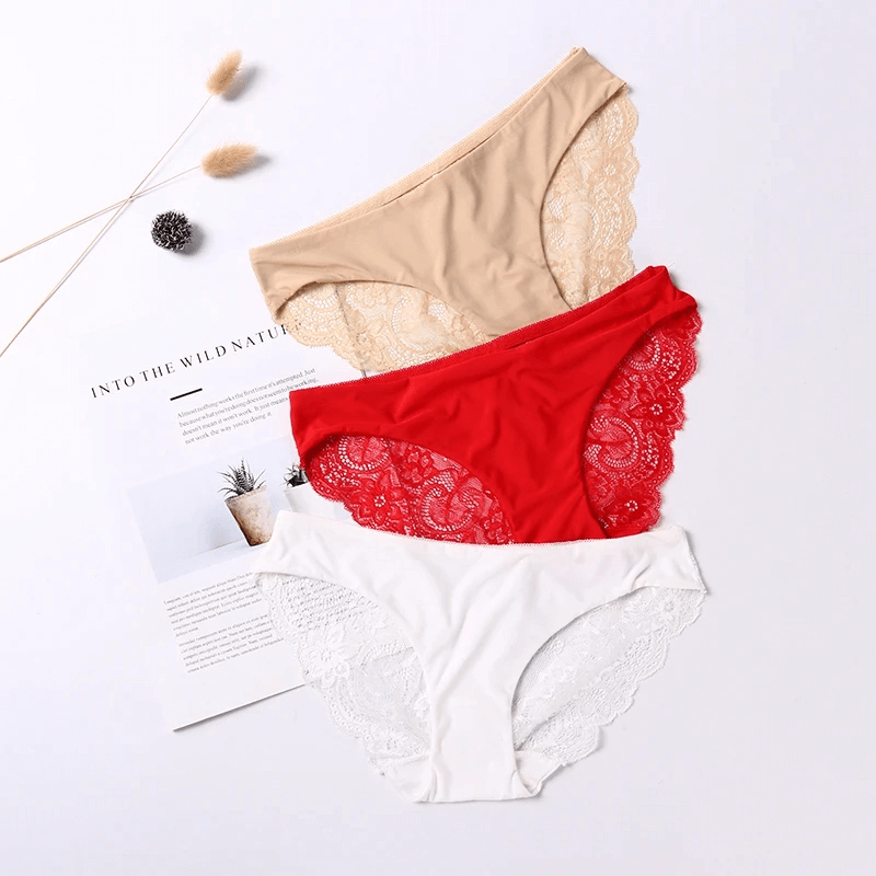 Set of three lace-trimmed elegant panties in beige, red, and white, showcasing delicate detailing for chic women's fashion.