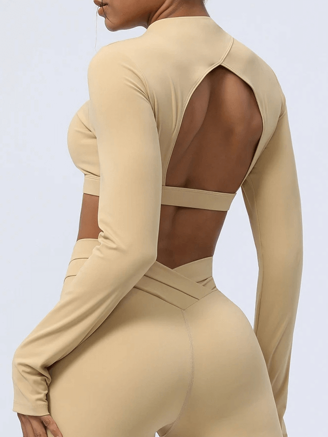 Elegant women's cut-out back yoga top in earth tone. Stylish fitness wear with unique back design for breathability and flexibility.