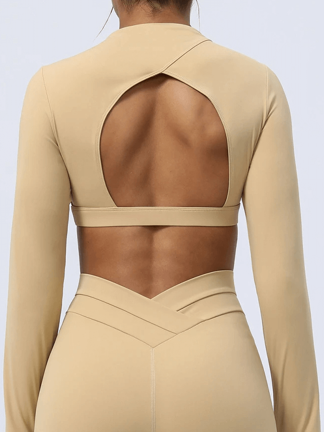 Back view of elegant cut-out back yoga top in earth tone, showcasing stylish design and breathability for modern active women.