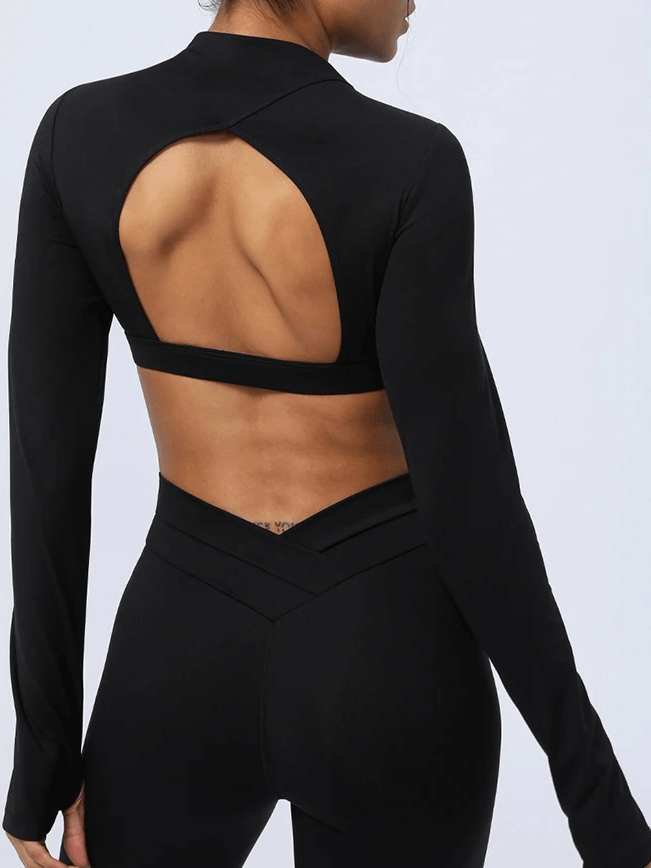Woman wearing a black cut-out back yoga top showcasing stylish fitness wear, perfect for movement and breathability, SF2104.