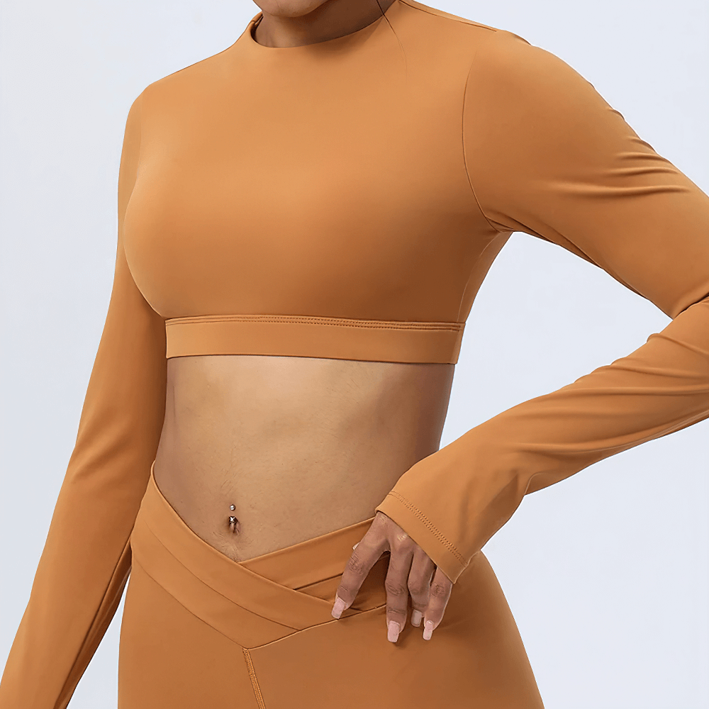 Elegant earth-toned women's cut-out back yoga top, stylish fitness wear for modern active women, provides flexibility and fashion.
