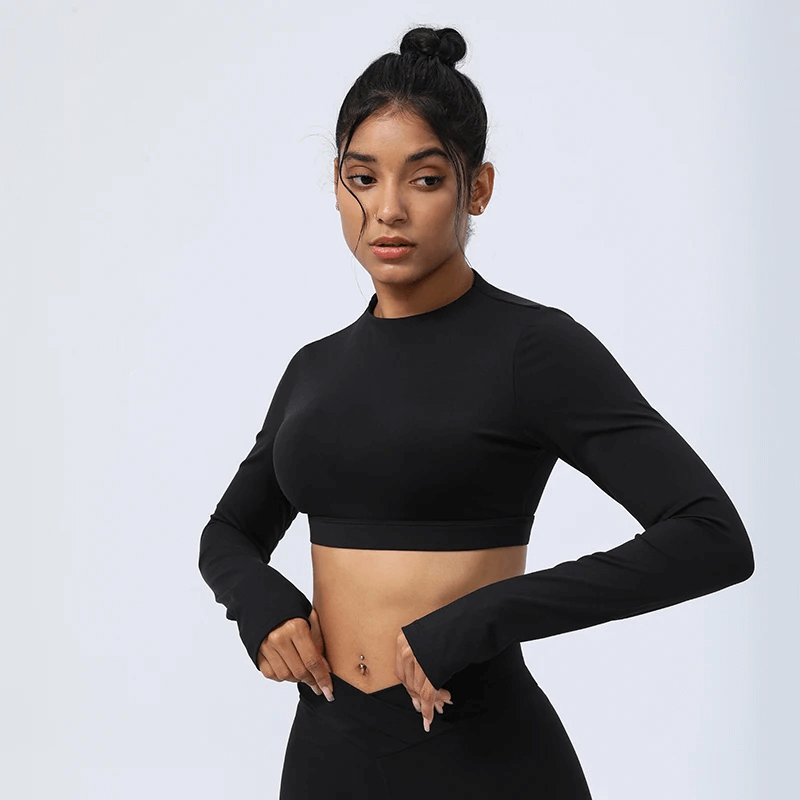 Elegant black cut-out back yoga top for women, designed for style and flexibility with long sleeves, perfect for yoga or pilates.