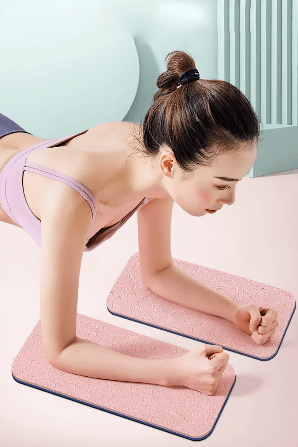 Woman using embossed pink elbow mats for yoga and fitness support, performing a plank on anti-slip, high-elastic cushions.