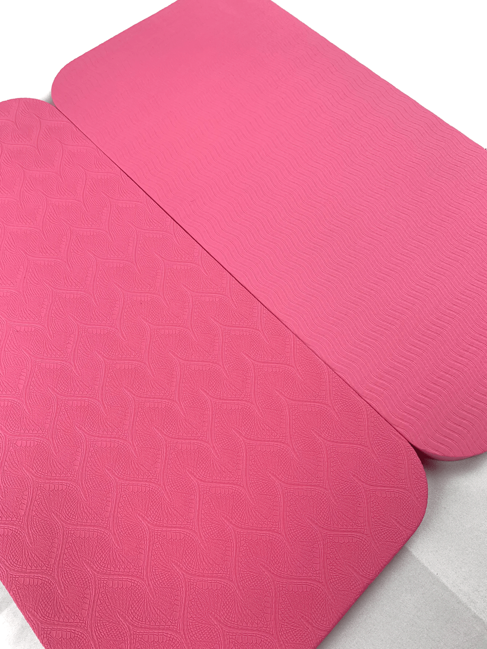 Pink embossed portable yoga mats for elbow and knee comfort, featuring anti-slip, pressure-resistant foam for gym and home workouts.