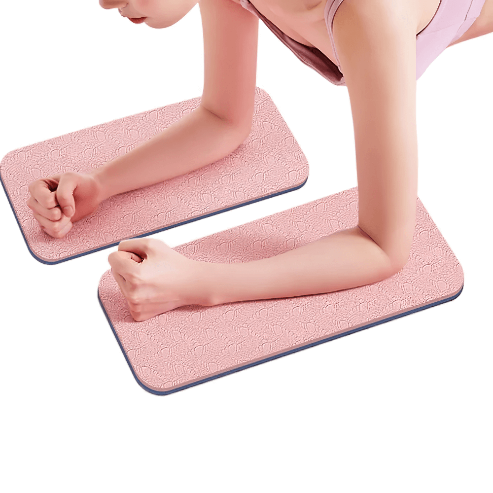 Person using pink embossed yoga mats for elbow support during exercise.