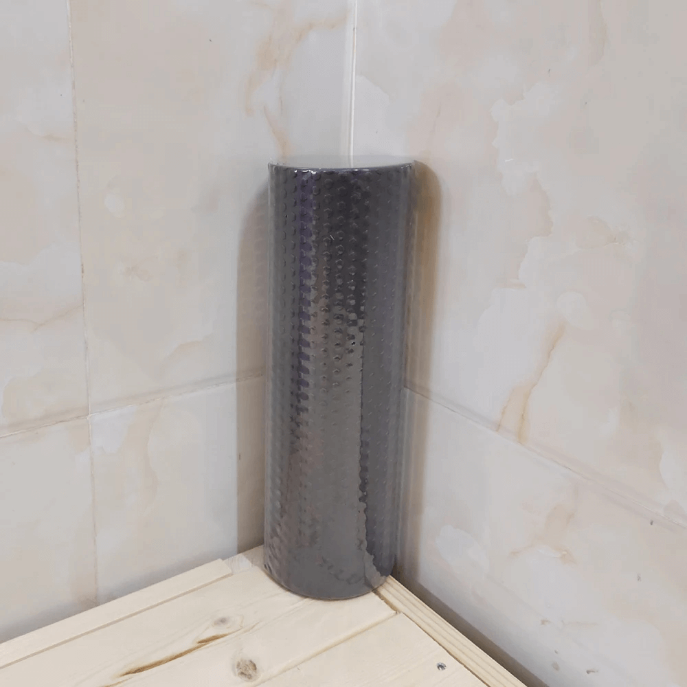 Black hexagonal EVA foam yoga roller for stretching and muscle relief, ideal for Pilates workouts and enhancing flexibility.