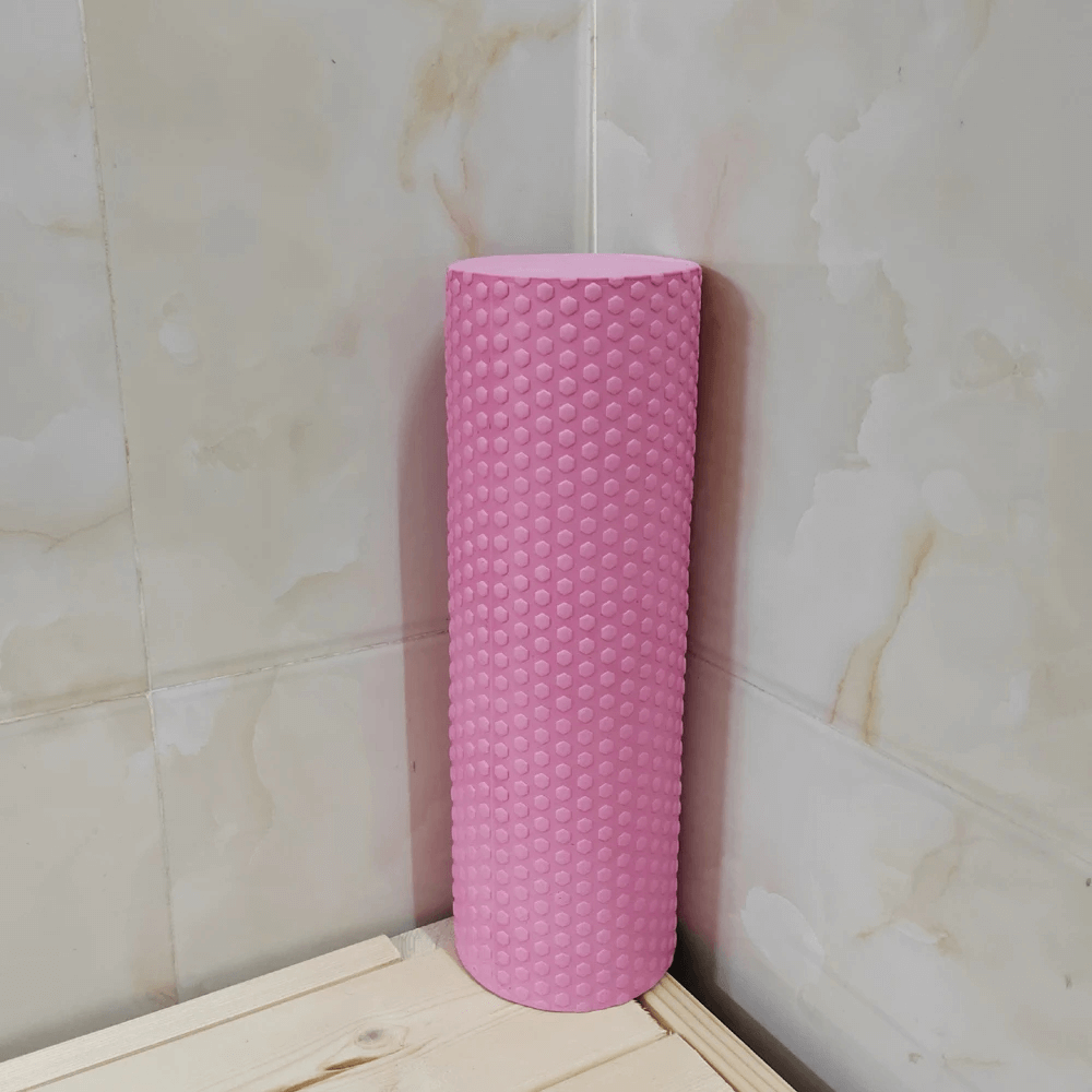 Pink hexagonal EVA foam yoga roller for Pilates and muscle relief, perfect for stretching, massage, and improving flexibility.