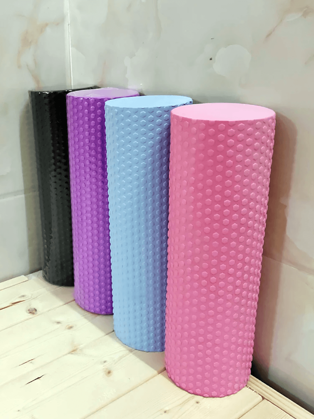 Colorful EVA foam yoga rollers with hexagonal texture for Pilates, stretching, and muscle relief. Perfect for home or studio use.