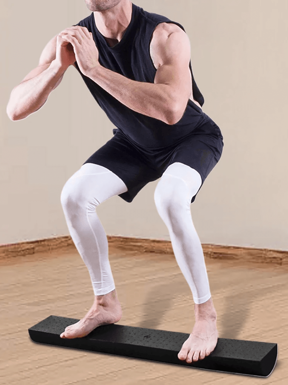 Man performing squat on EVA half-round foam roller for balance and stability.