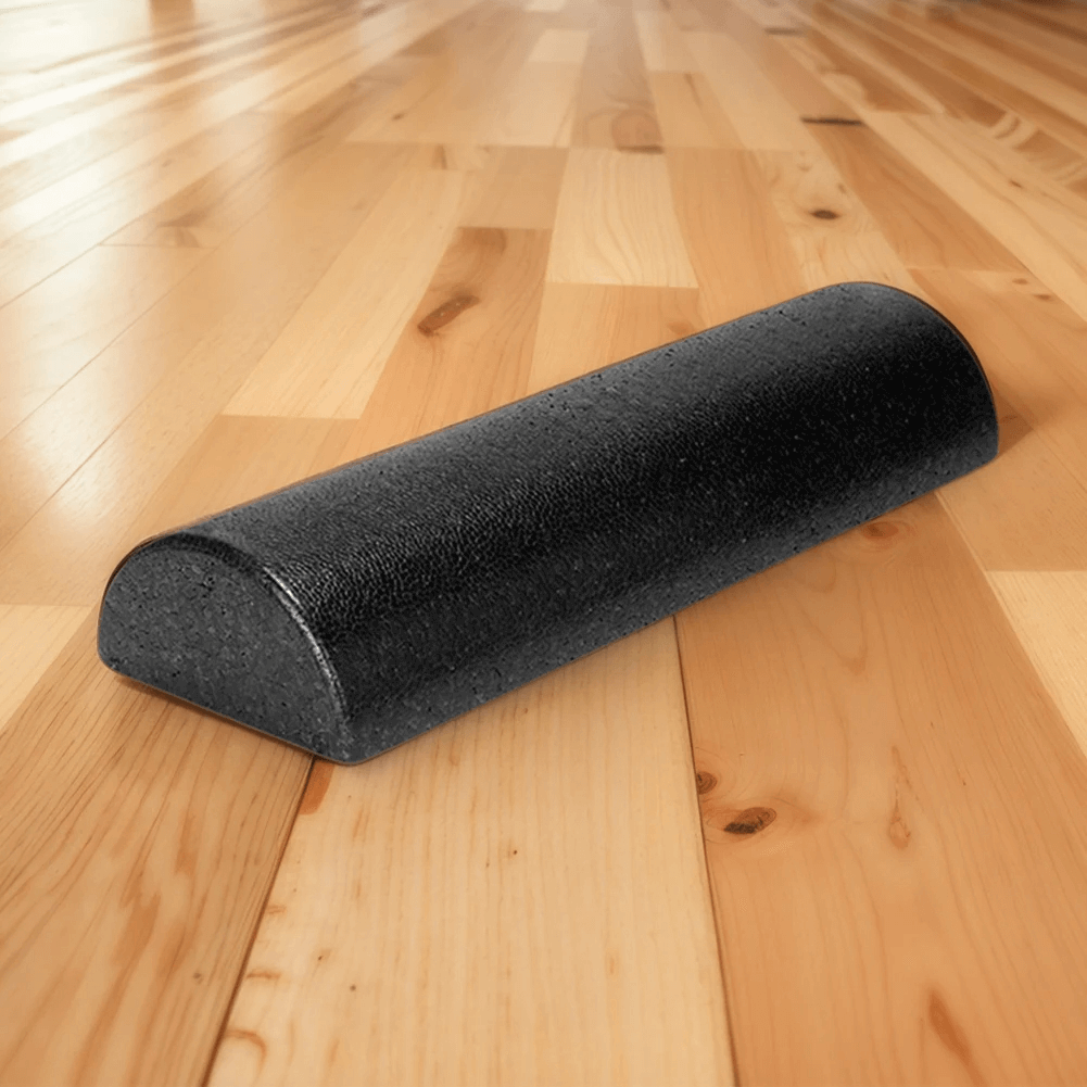 EVA half round balance foam roller for yoga and gym on wooden floor, perfect for Pilates, rehab, posture, and ankle strengthening exercises.