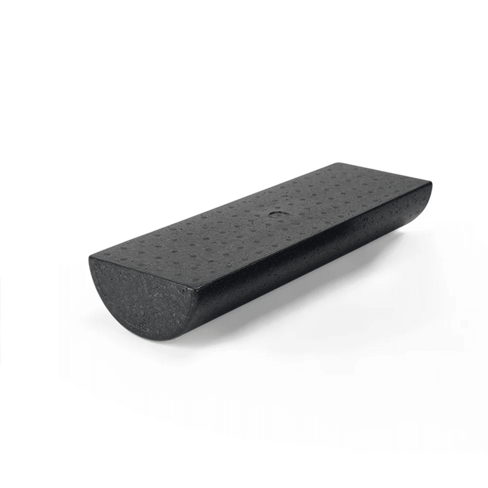 Black EVA half round foam roller for yoga, Pilates, and rehab with textured surface for balance and stability exercises.