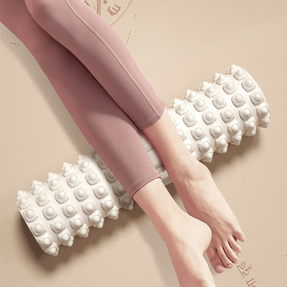 Person using EVA textured massage roller for deep tissue muscle relief and recovery, focusing on legs, shown in a home workout setting.
