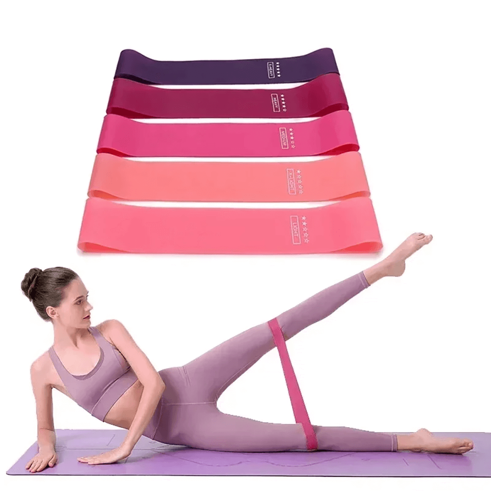 Woman using exercise loop bands for home workouts. Fitness and strength training with colorful resistance bands for flexibility and toning.