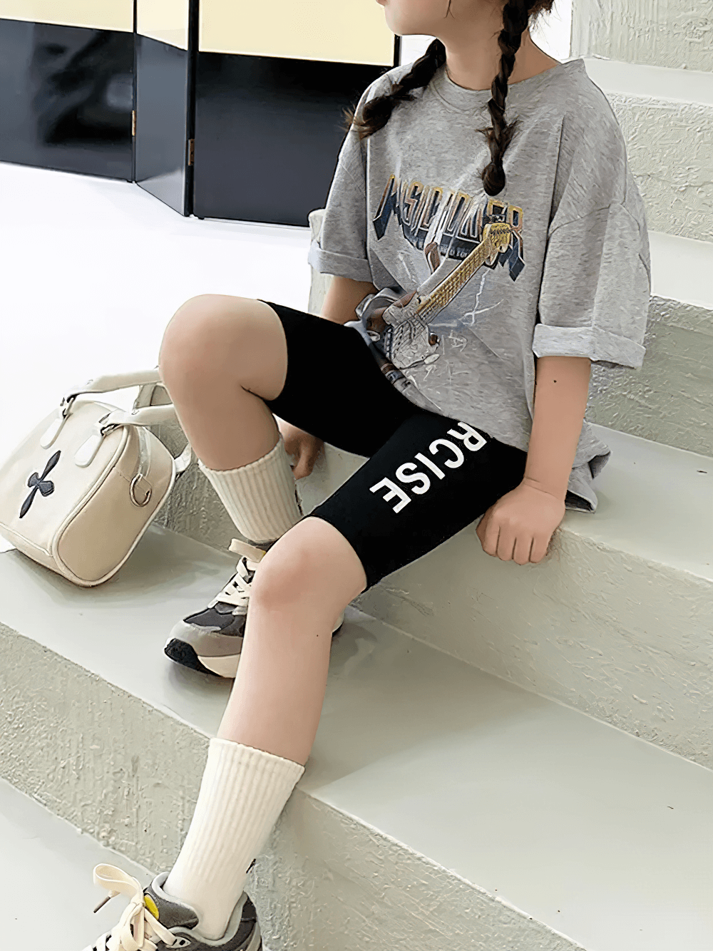 Child wearing Exercise Print Stretch Biker Shorts for Active Wear - SF3758, sitting on steps in casual sporty outfit.