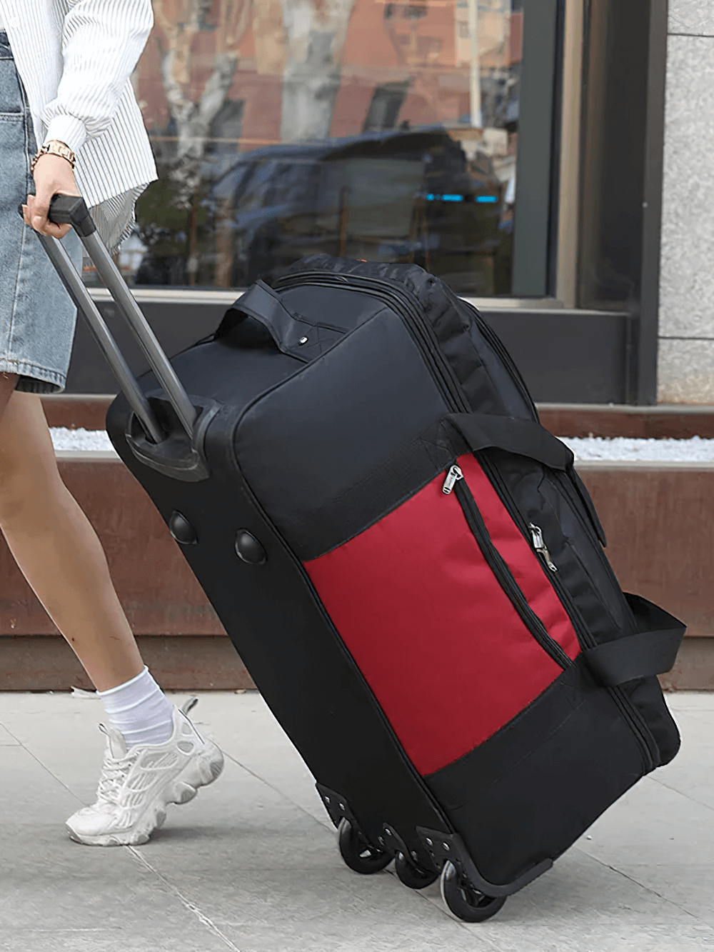 Expandable travel suitcase on wheels with red accent being pulled by traveler - SF2667