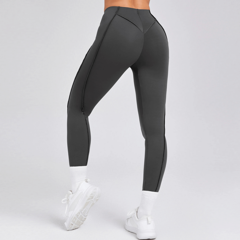 Woman wearing Exposed Seam High Waist Yoga Leggings - SF4056 showing back view with sleek design perfect for fitness.