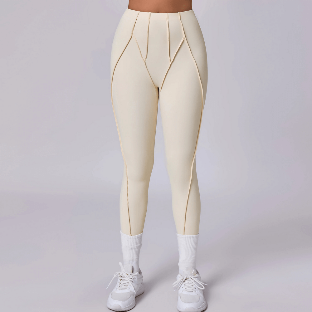 Model wearing Exposed Seam High Waist Yoga Leggings - SF4056 in cream, showcasing squat-proof design and high waist fit for active wear.