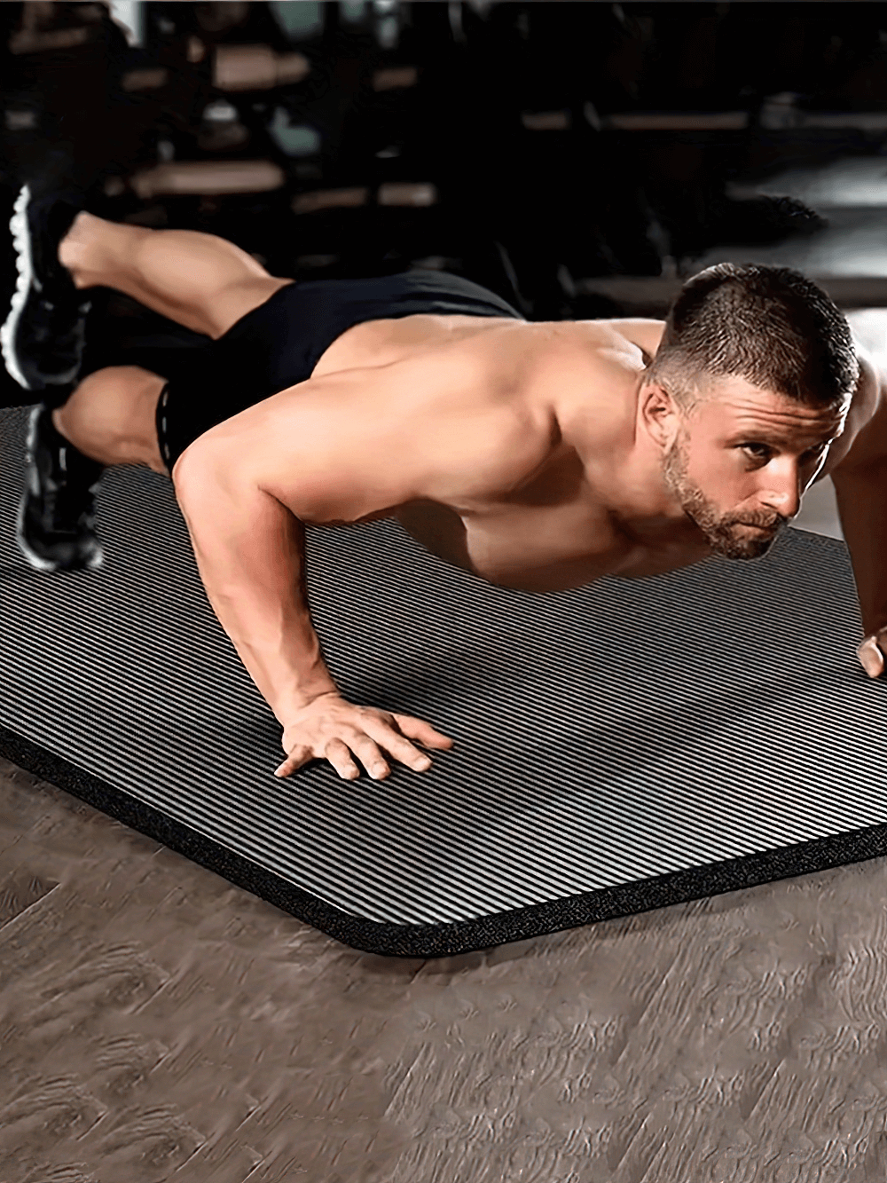 Man doing push-ups on an extra thick non-slip exercise mat, ideal for joint protection, with high-density material for impact absorption.